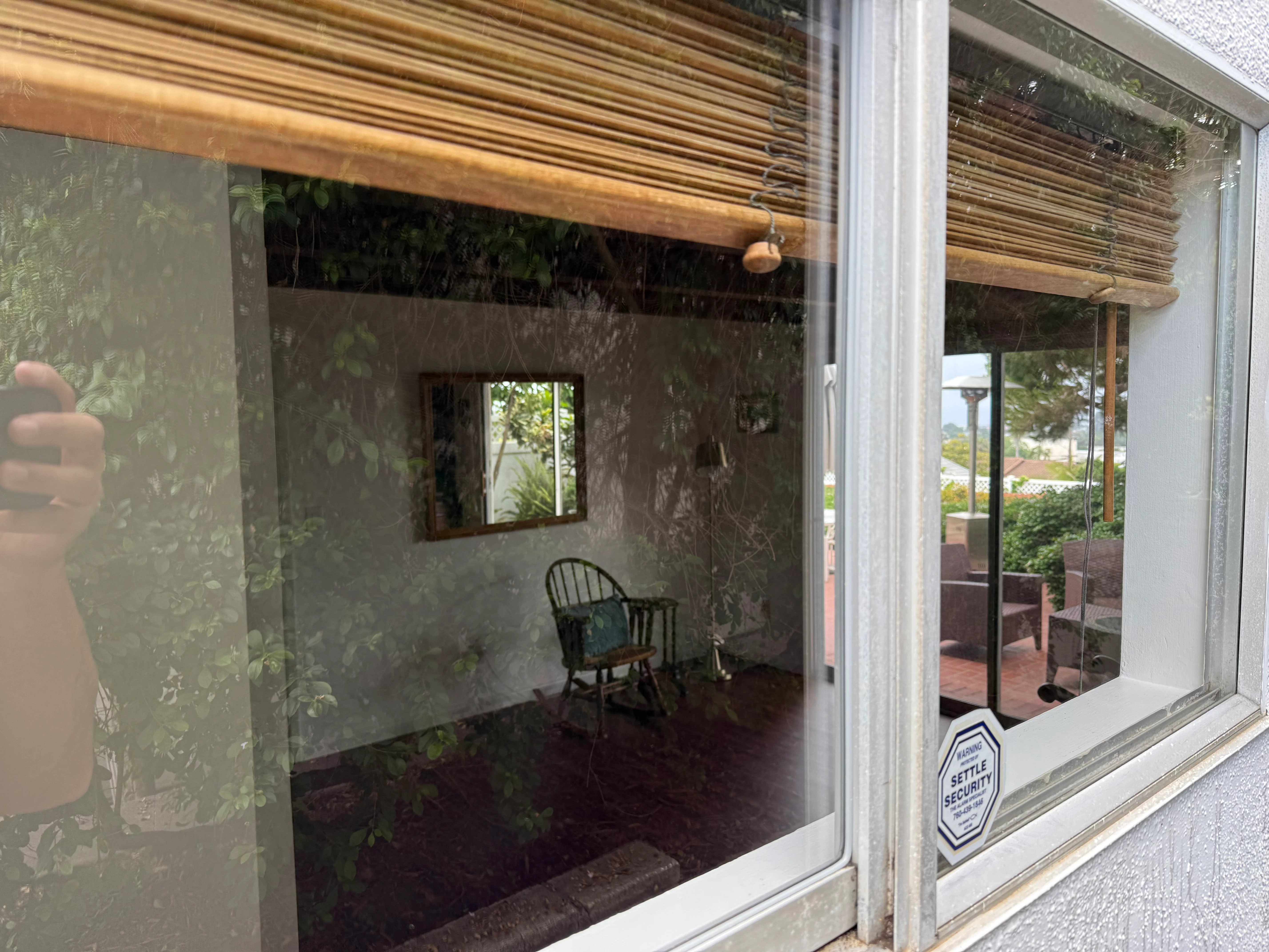 Clean residential windows and glass doors with white frames overlooking patio area
