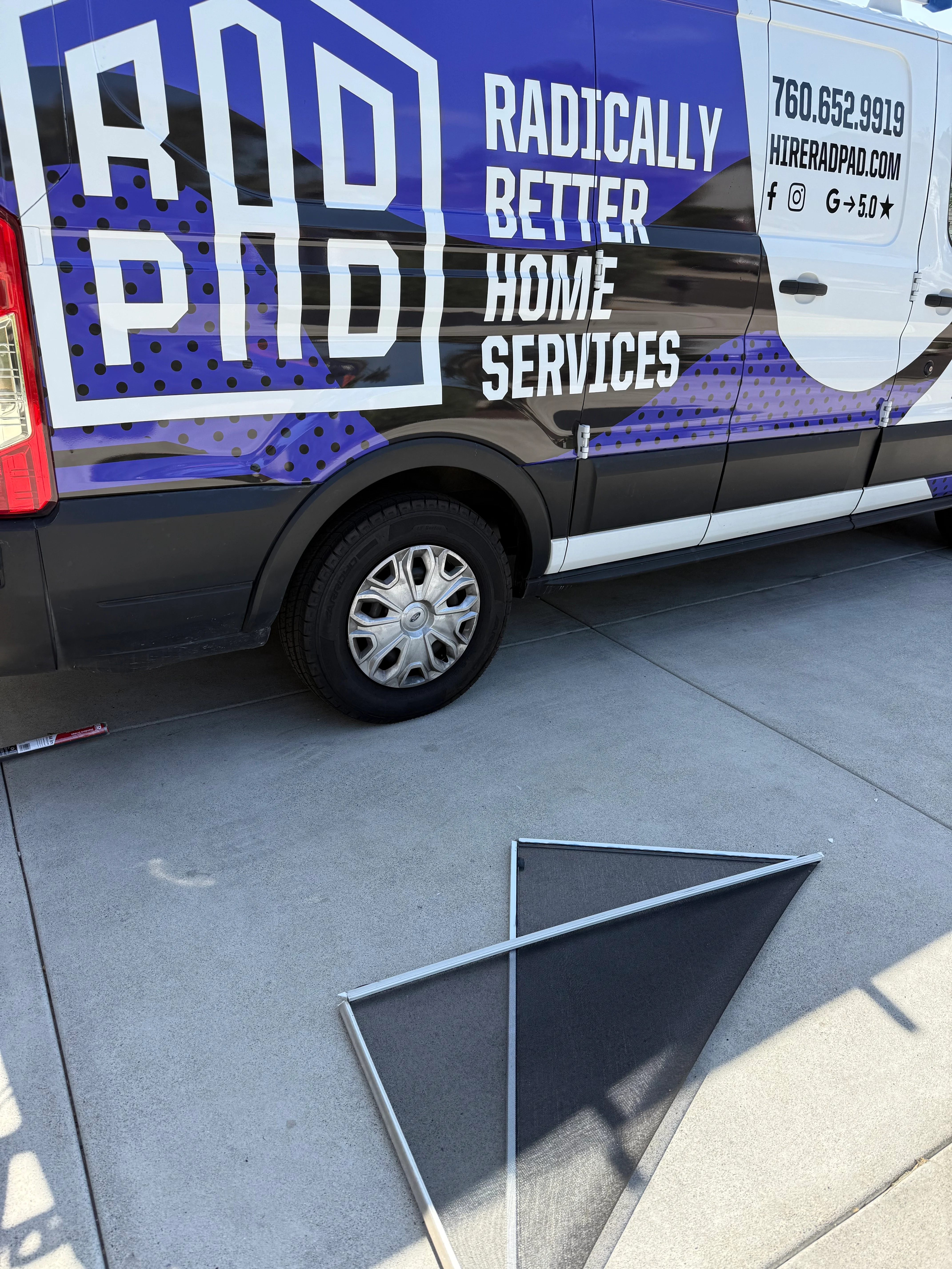 Blue and white service van wrap with RadPad branding and contact details