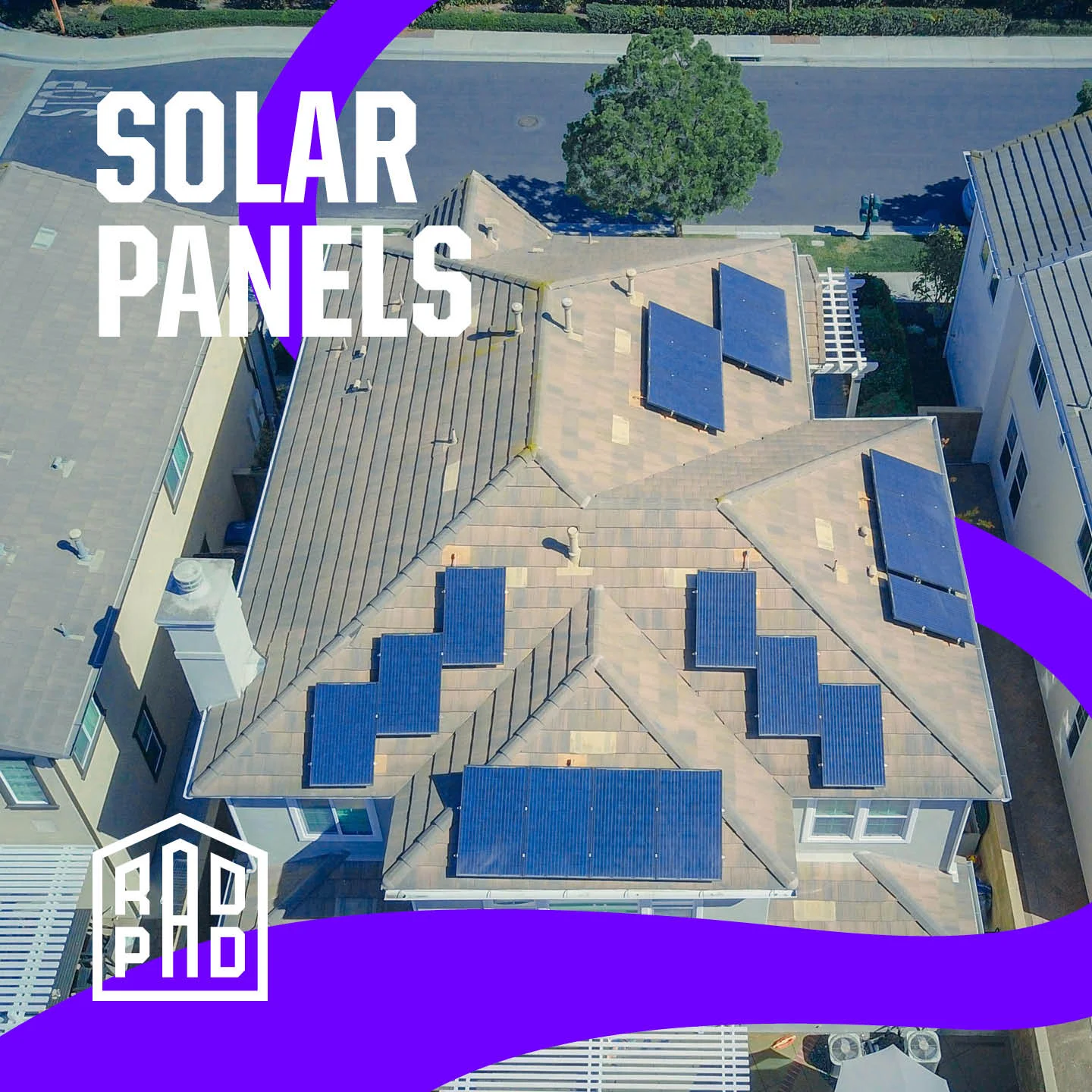 Aerial view of cleaned blue solar panels on multiple residential rooftops in San Diego