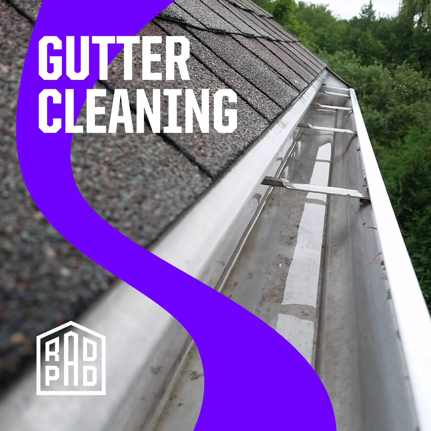 Clean white aluminum gutters along residential roofline with asphalt shingles visible