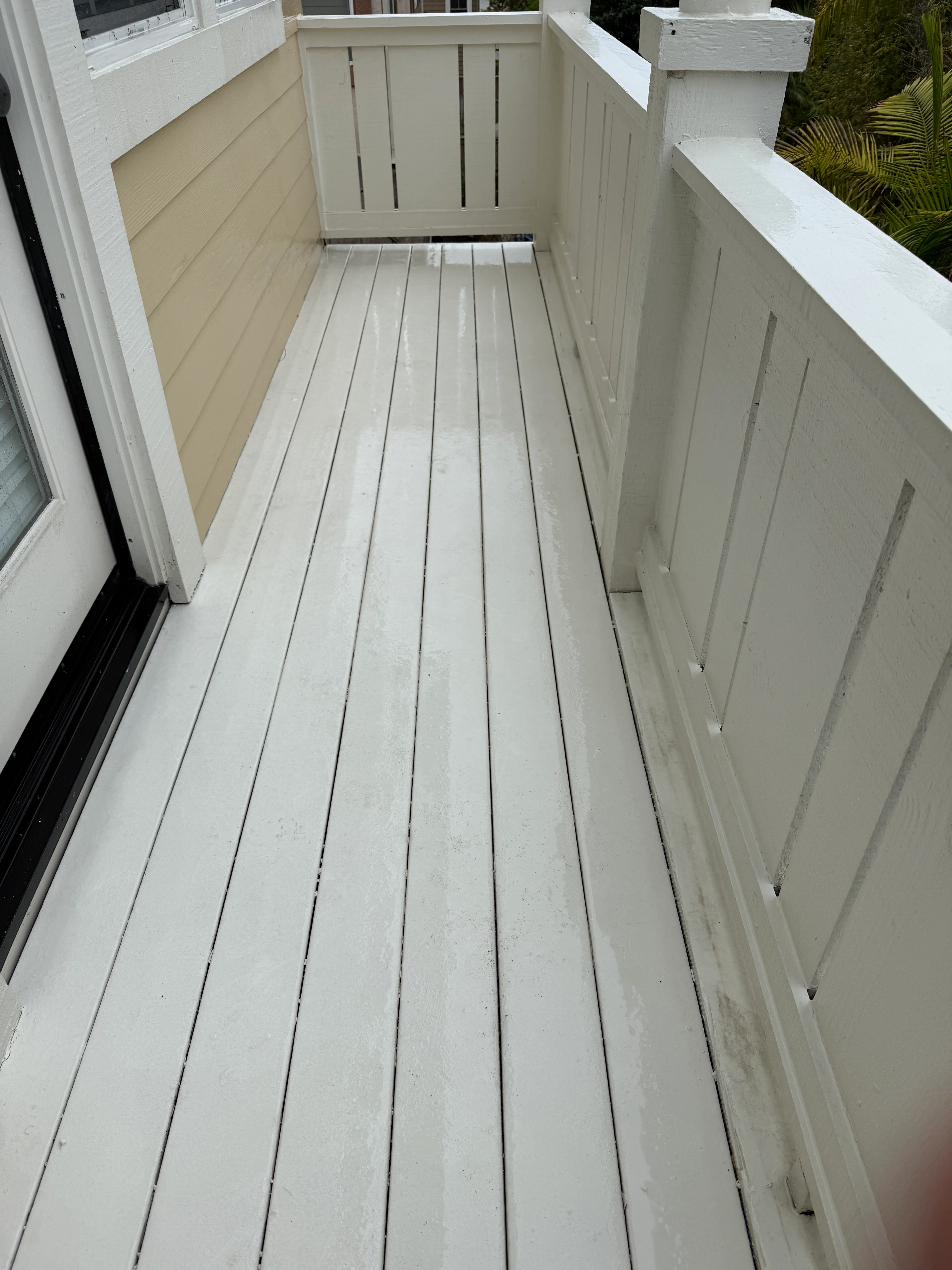 Clean white composite deck with railings after professional cleaning service